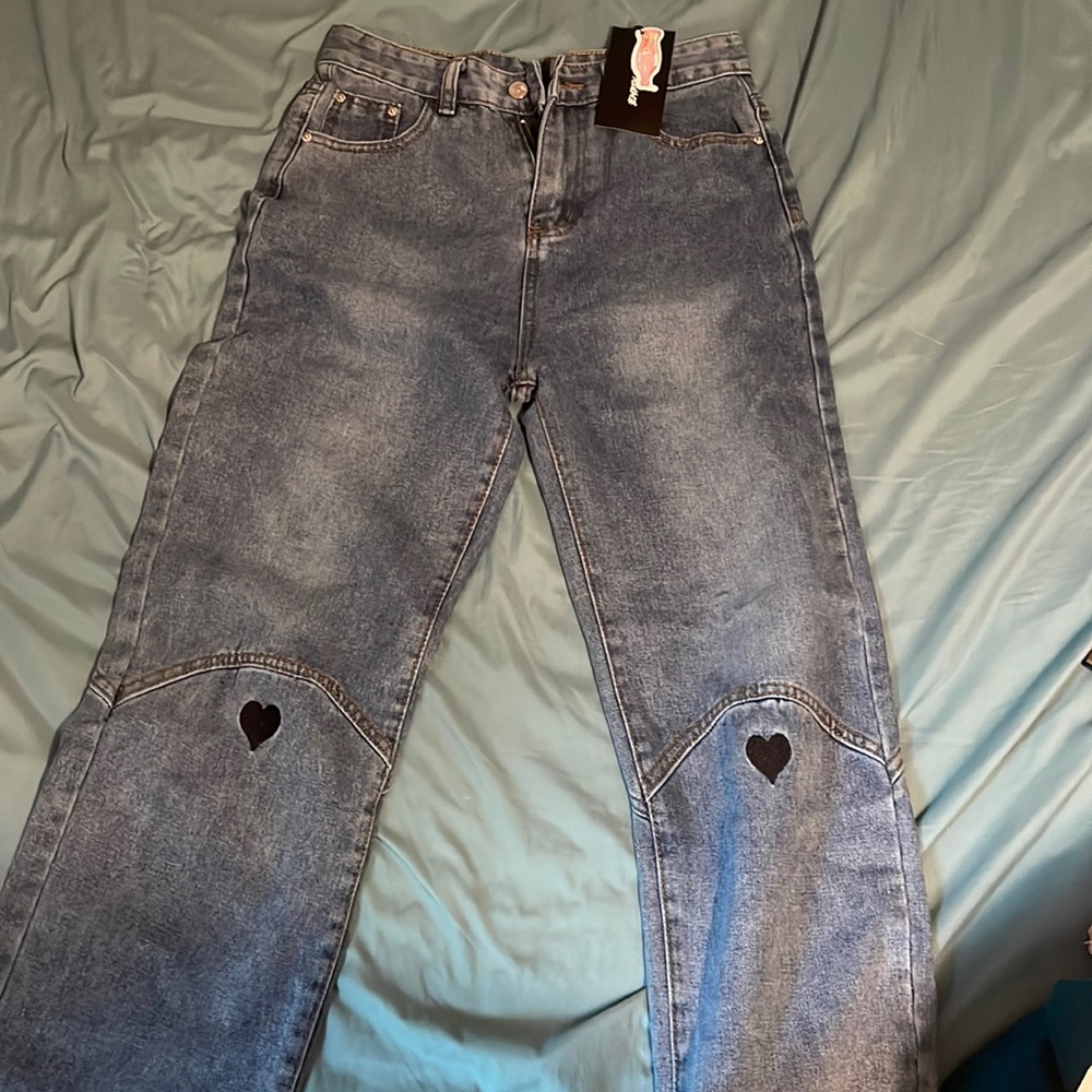 Empty soda heart at knee full length jeans